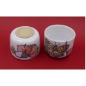 Two vintage stacked ceramic cups with retro butterfly and flower pattern 1970s