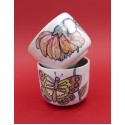 Two vintage stacked ceramic cups with retro butterfly and flower pattern 1970s