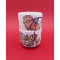 Two vintage stacked ceramic cups with retro butterfly and flower pattern 1970s